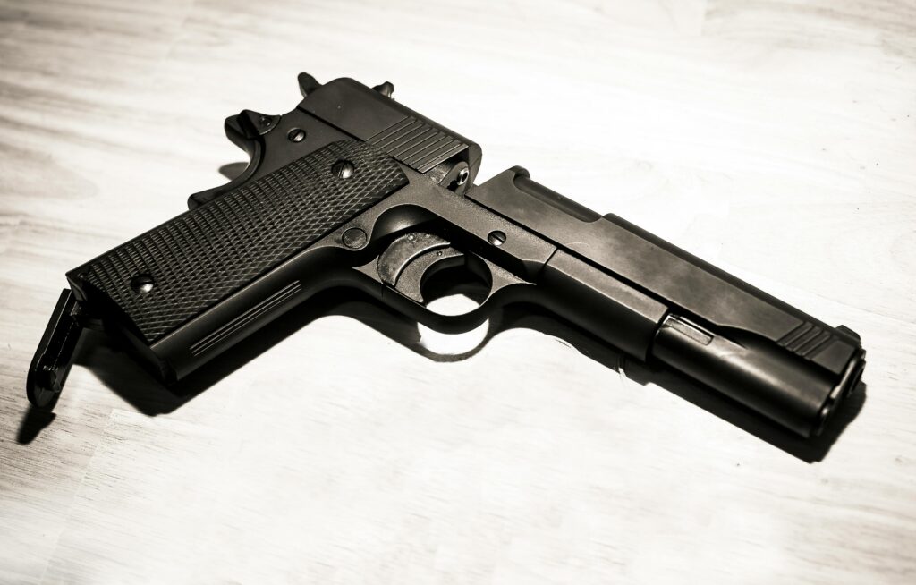 Compact handgun placed flat on a surface for home defense.