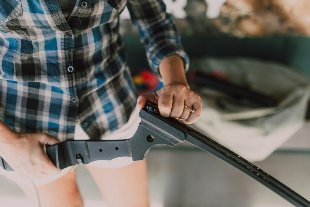 Person in Plaid Shirt Holding a Rifle